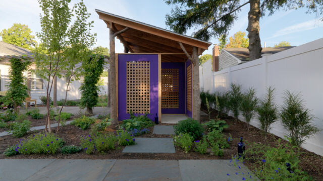 After: outdoor structure with bluestone patio and plantings surrounding