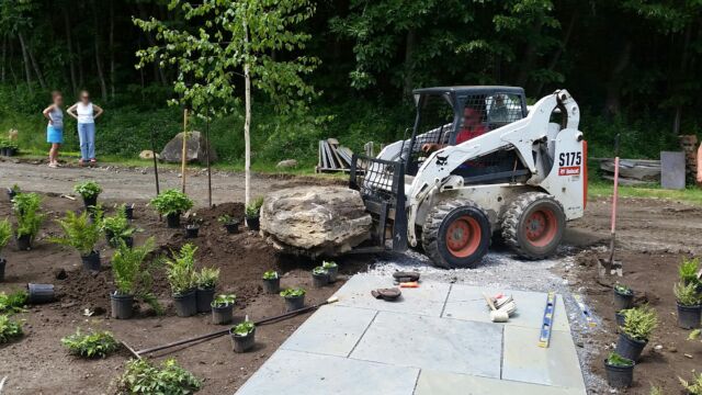 Installation: Installed a bluestone walkway, moved boulders from the site to give a woodland feel. Plants are being laid out to be planted.