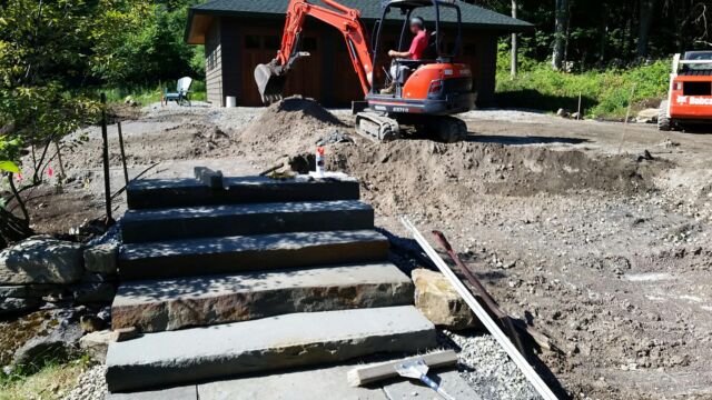 Installing bluestone steps and a walkway to connect the front porch to the parking area.
