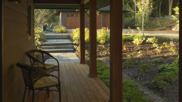 After: Front porch overlooking woodland gardens, bluestone steps and walkways, and a cocktail patio.